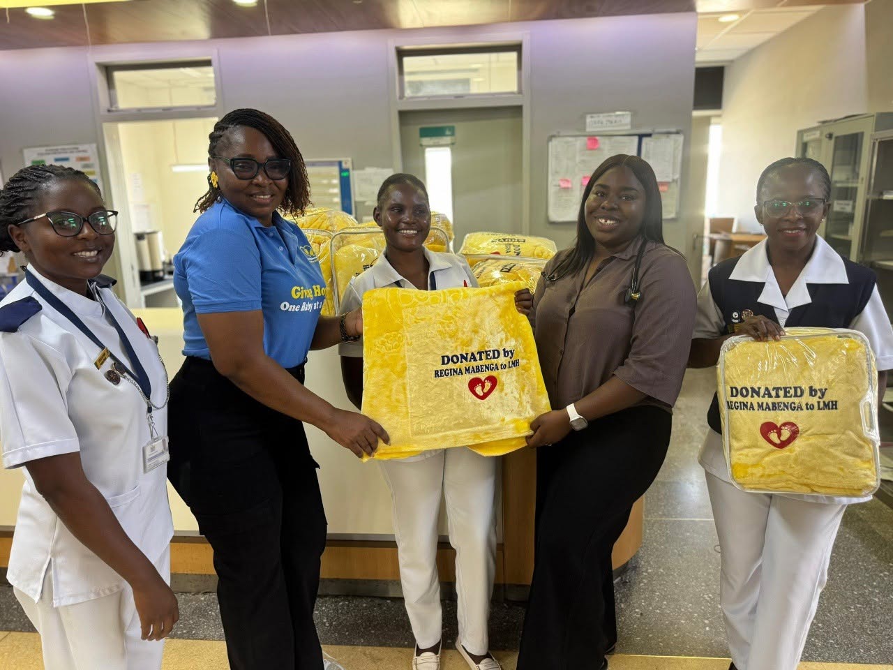 HSSI team donating baby blankets to neonatal ward staff at Levy Mwanawasa Hospital